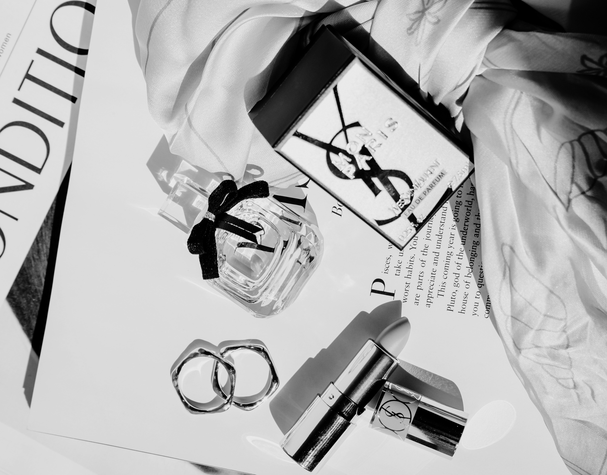 Perfume Bottle and Lipstick on a Magazine